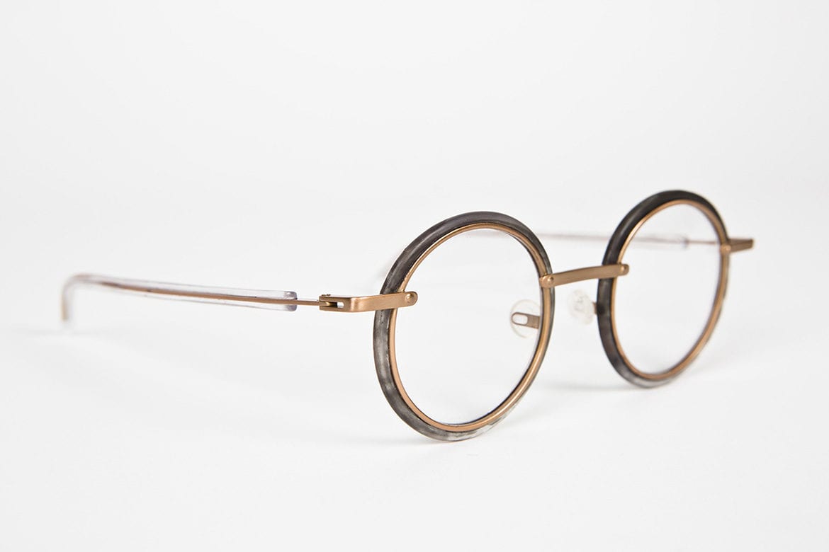 Gold circle glasses on a white surface