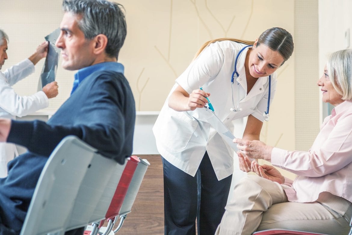 The doctor is discussing an issue with an elderly woman.