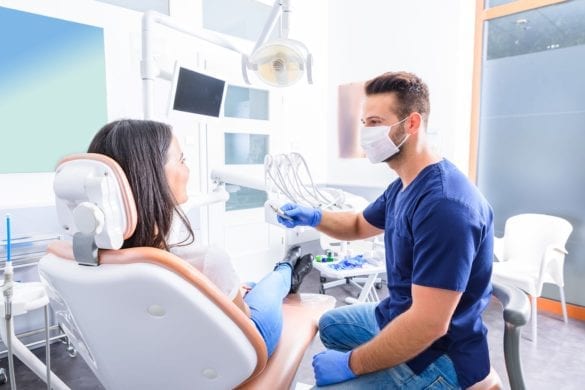 Dentist Speaking to Female Patient
