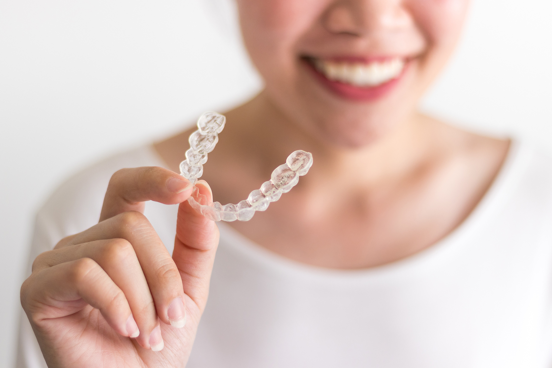 woman holding transparent teeth brace - eds blog - the daily tooth