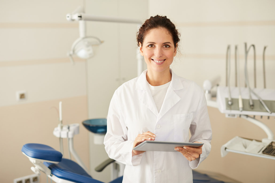 dentist with paperwork dentist with paperwork