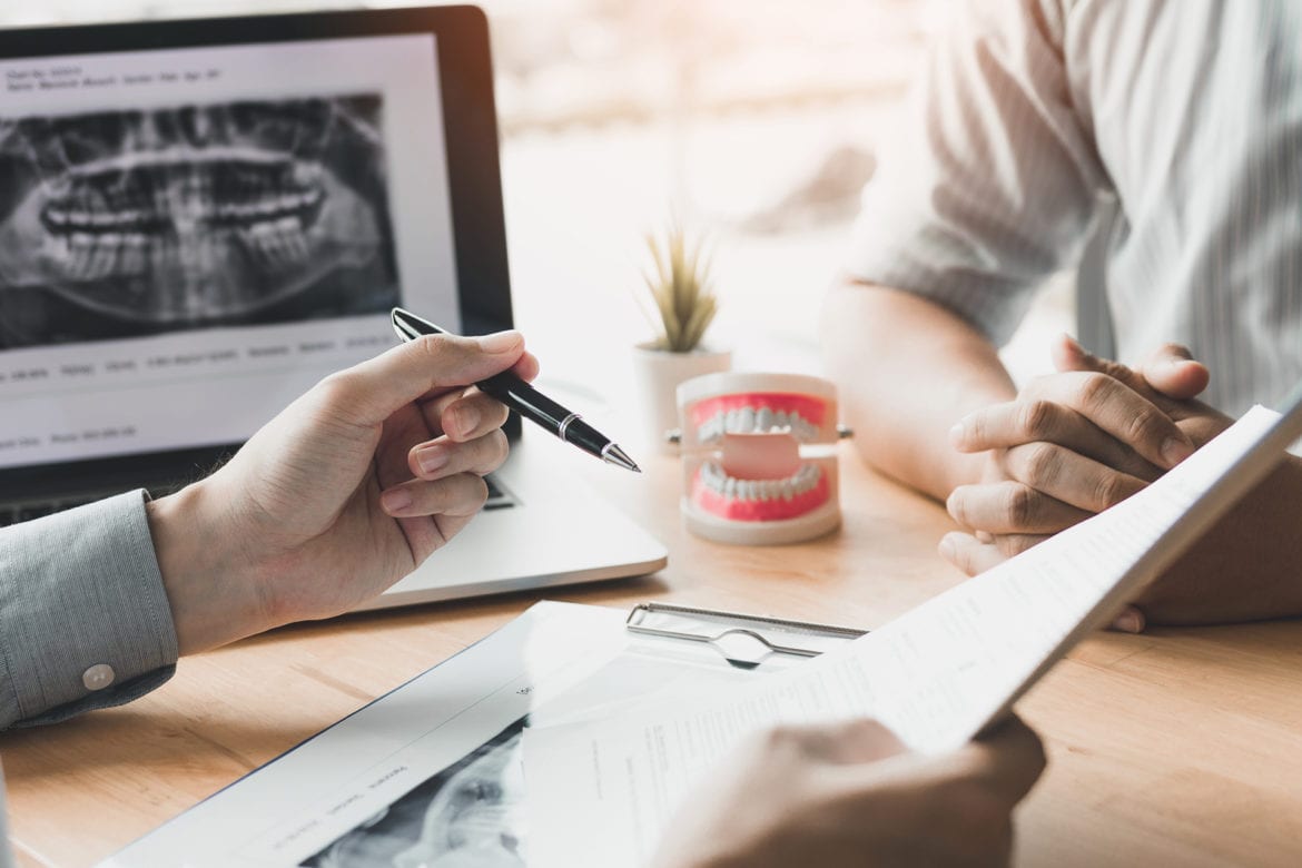 Dentist and patient discussing dental issue