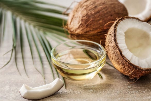fresh coconuts along with oil poured into the cup