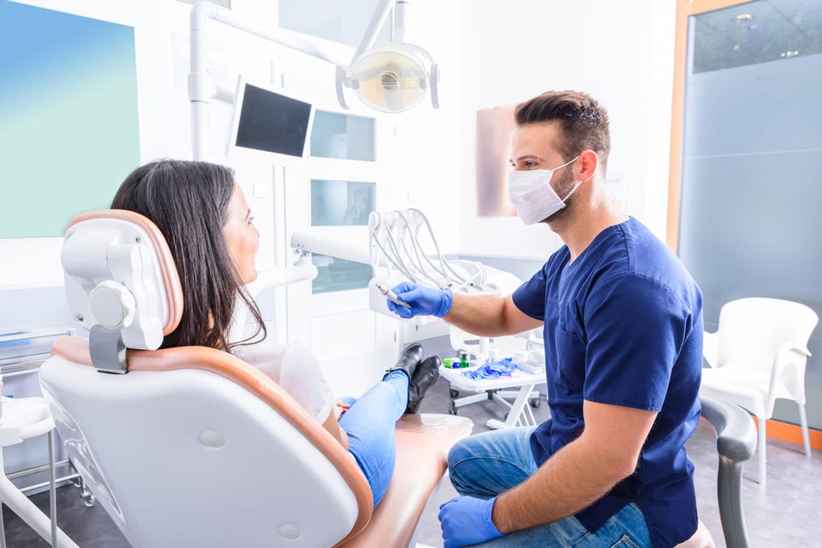 Dentist showing patient a dental tool