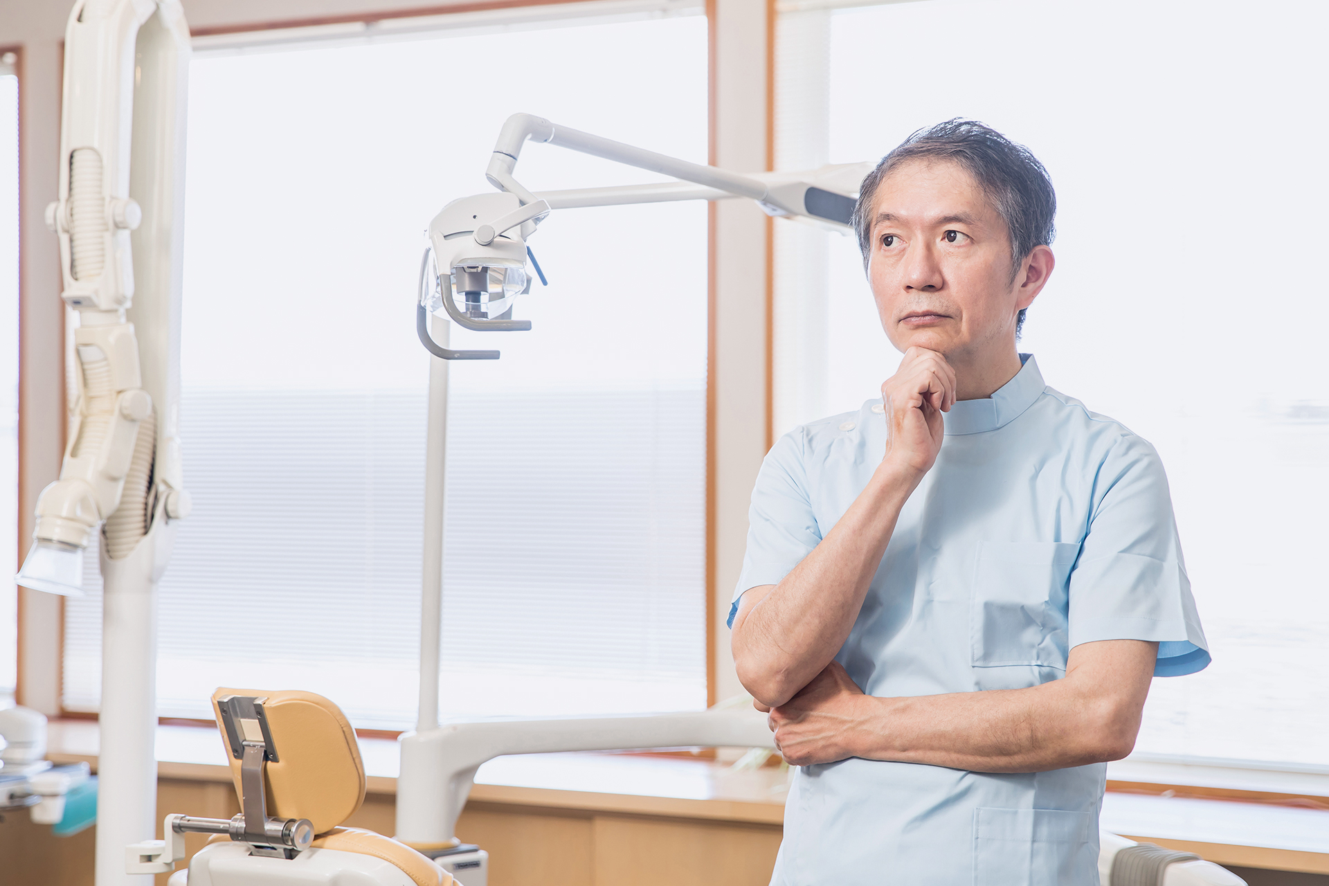 dentist thinking about something in his dental office