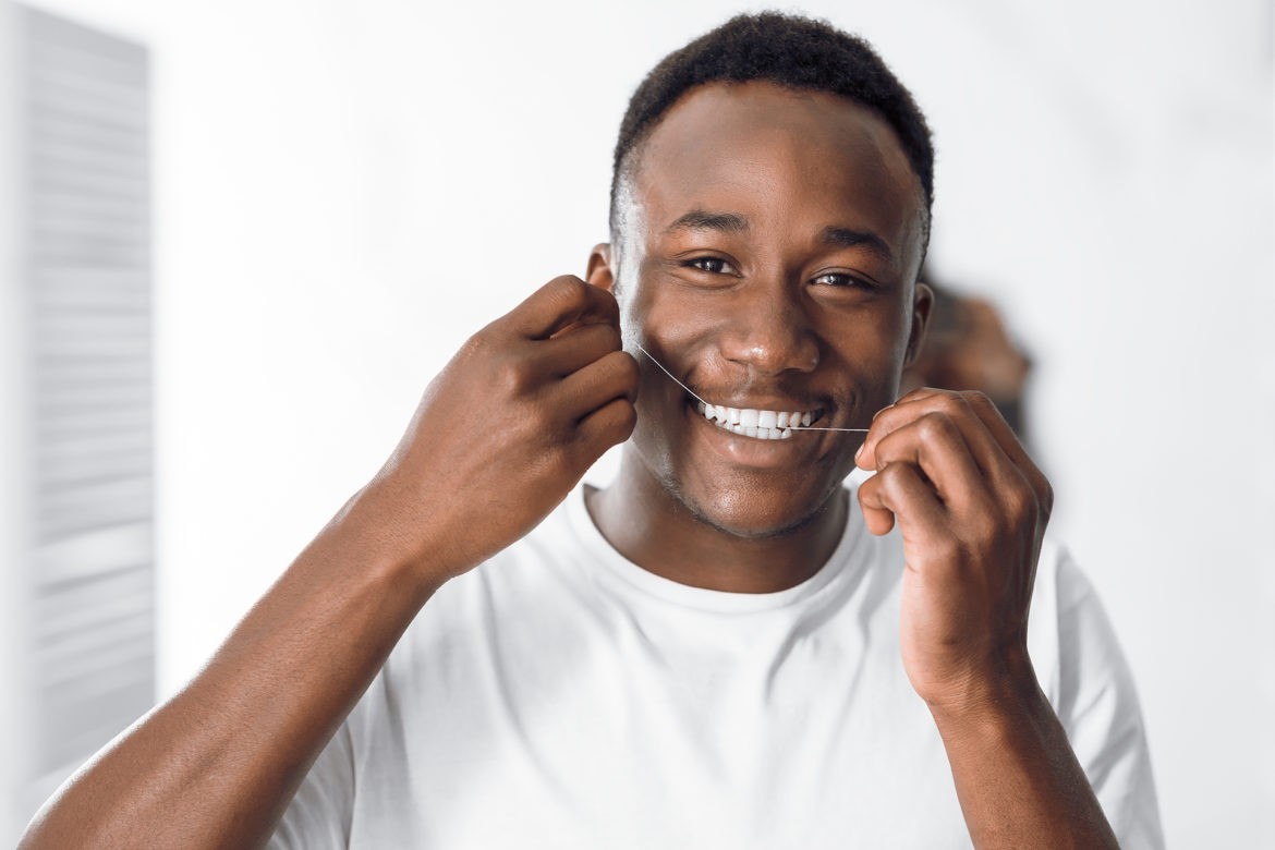 A man flossing his teeth