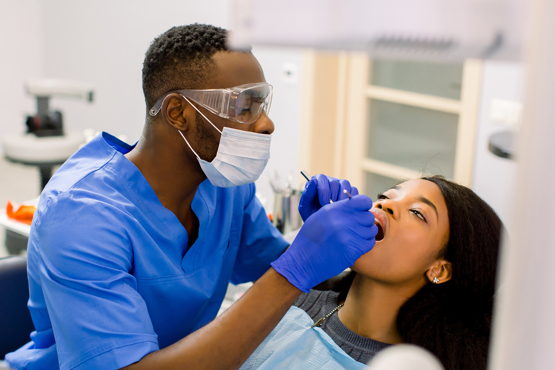 Dentist providing dental care to a female patient