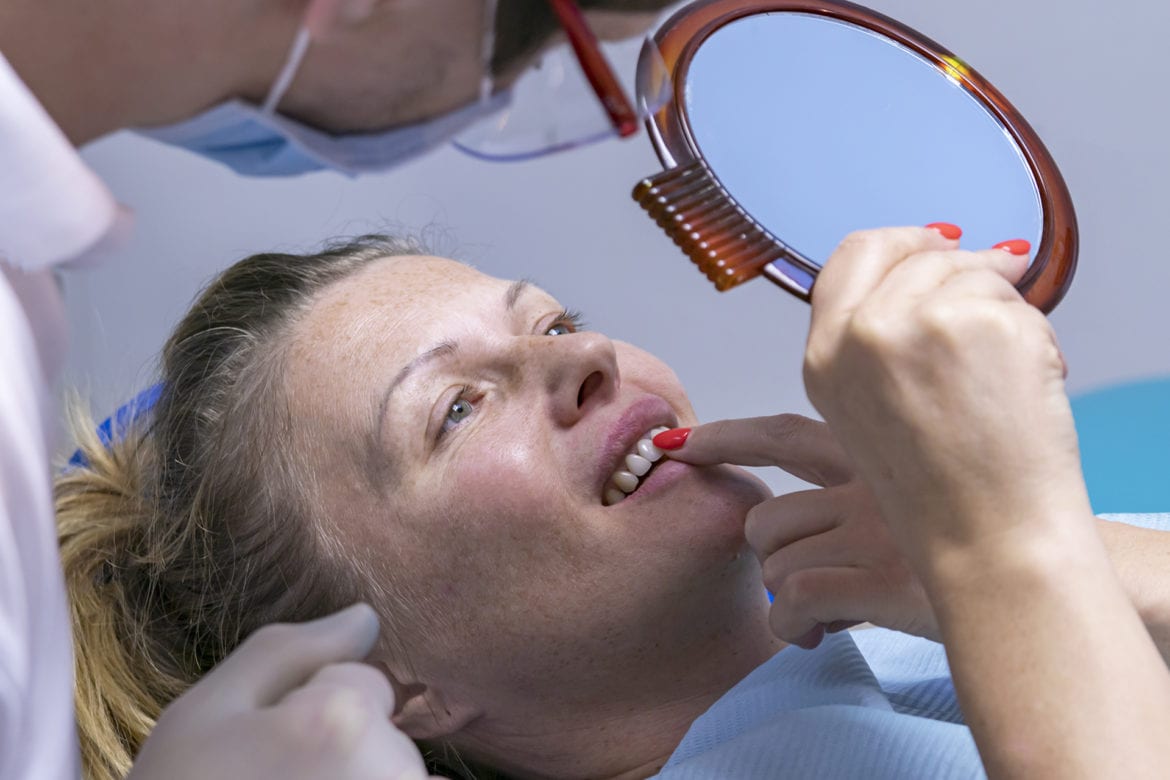 A woman is being treated for gum recession.