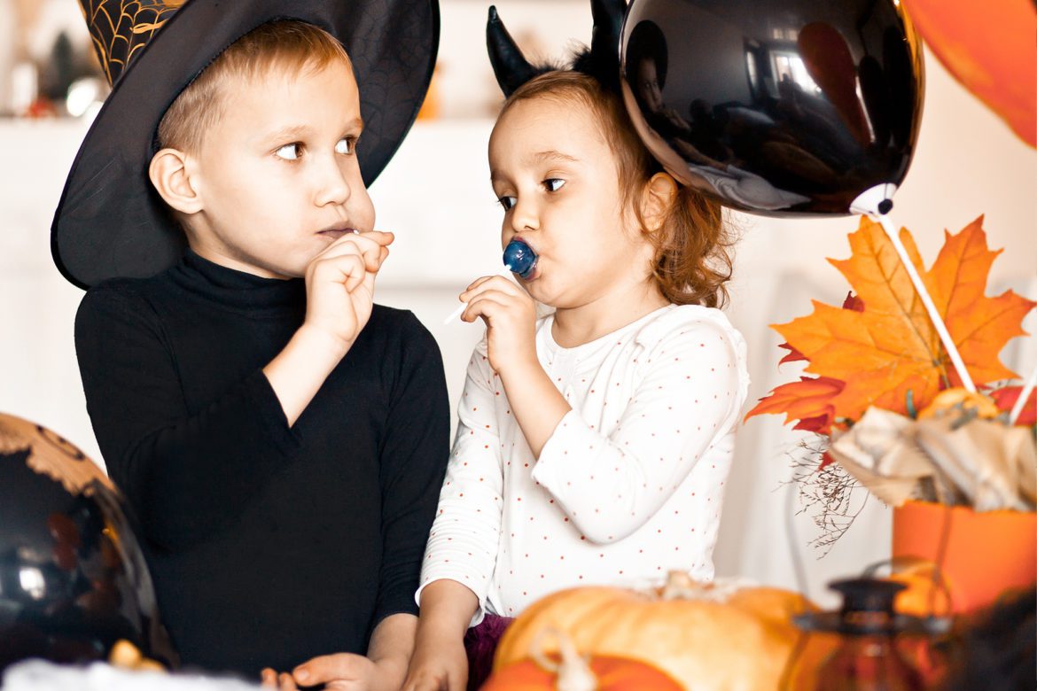 blog-eds-holloweencandy Boy and girl eating candy during Halloween