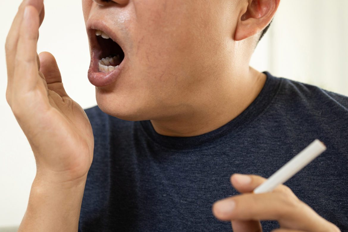 A man smoking with bad breath