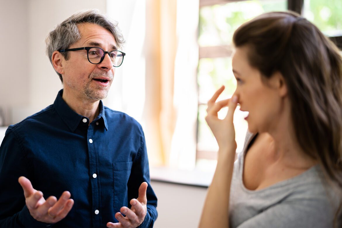 eds - woman talking with man with bad breath.