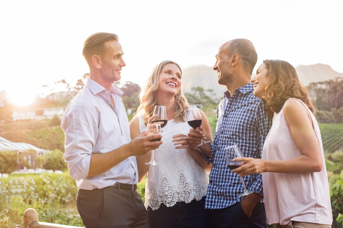 Group of friends smiling and talking outside