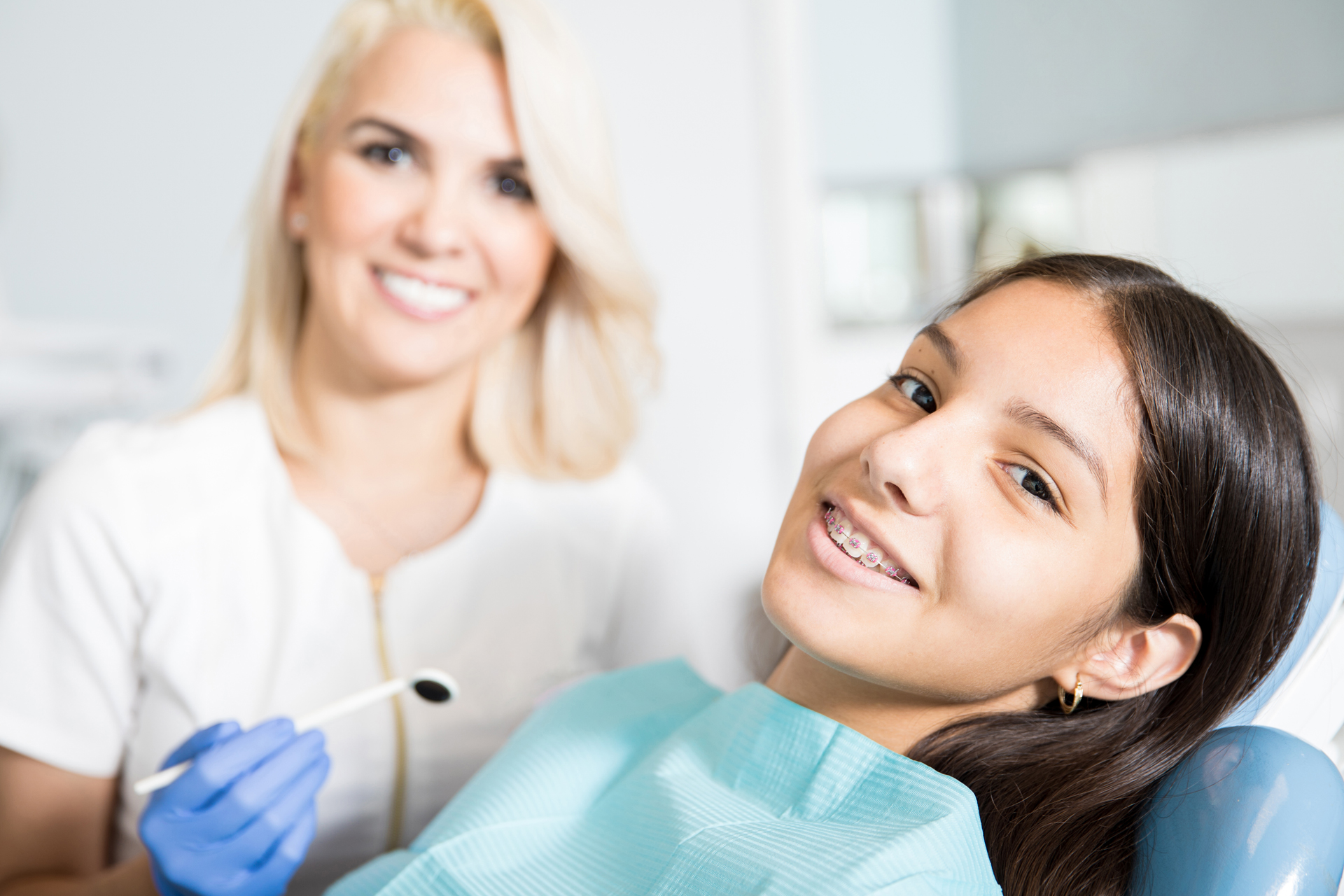 eds - Woman with dentist smiling while looking forward.