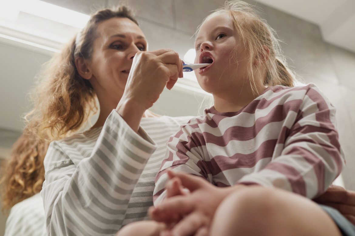 A child with special needs is being examined by a dentist.