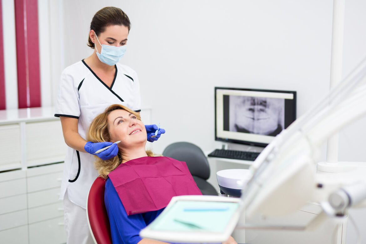 blog-eds-teethNmenopause101323 middle-aged woman receiving dental care from a dentist