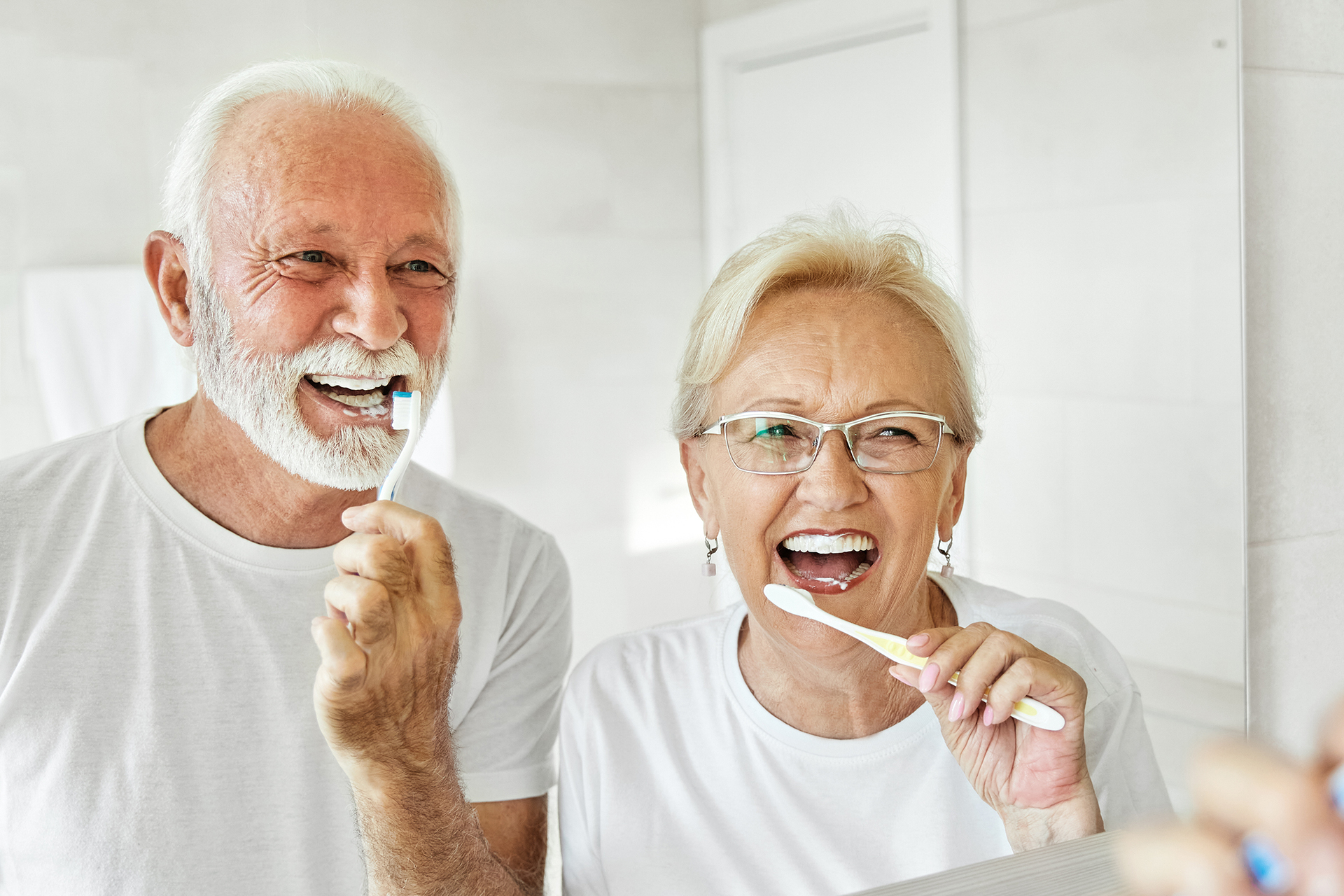 Elderly couple brushing teeth