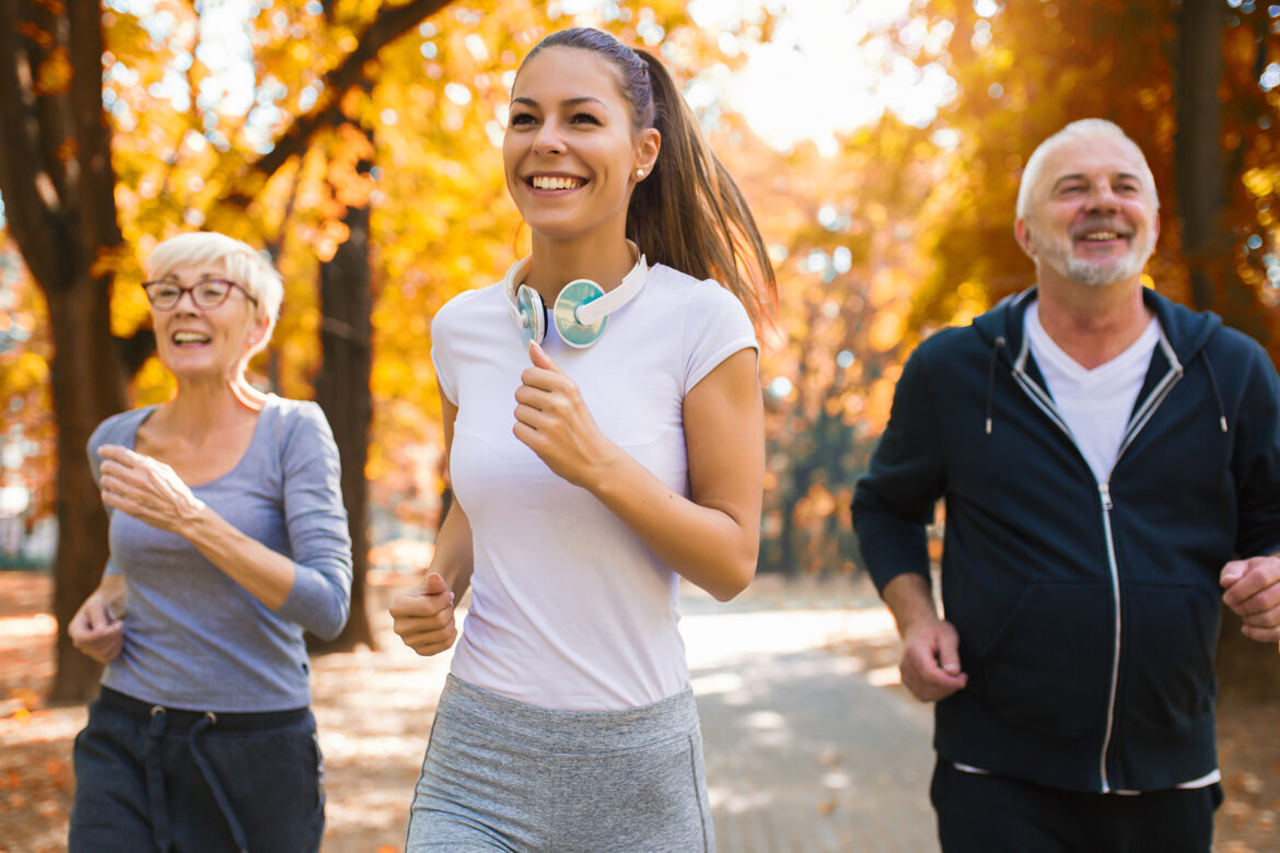A young woman is jogging with an elderly couple.
